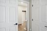 View of Jack and Jill bathroom from 3rd bedroom- walk in closet on right.