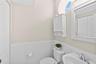 The main living level has a powder bath with linen closet for additional storage.