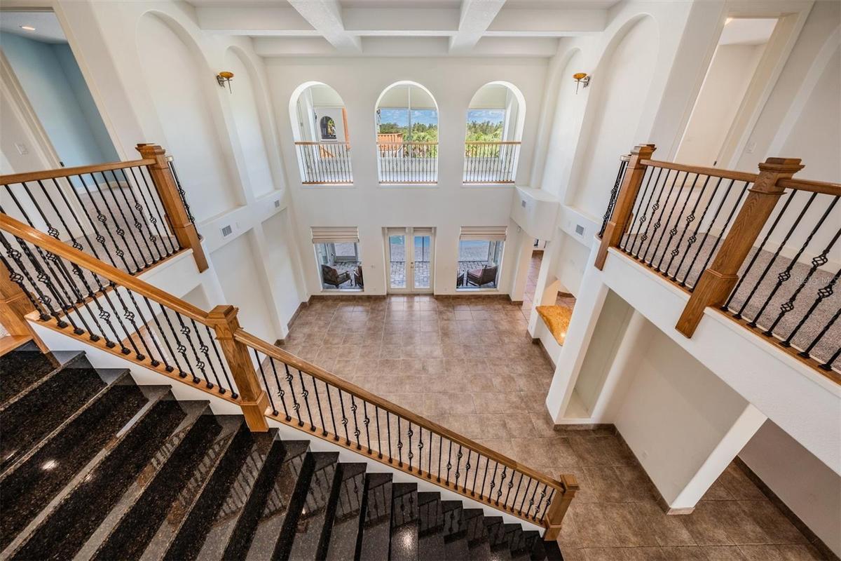Granite staircase overlooks dramatic Great room