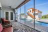 Screened back porch with pool views