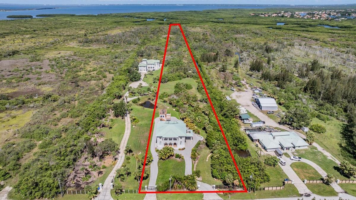 5 Acres with access to canal on right and floating dock at rear