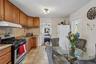 Upper Unit 2 - Modern Kitchen with a wall of Closets.