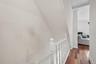 Hallway leads to the Bathroom & Stairs to the lower level of this up-side-down-unit!