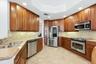 Tall wooden cabinetry, stainless appliances and granite countertops