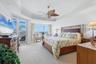 Primary Bedroom, coffered ceiling, with motorized room darkening shades, private access to lanai