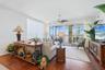 Great Room with Engineered Hardwood Floors, triple sliders leading to covered lanai