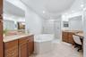 Primary Bathroom with deual sinks, vanity granite counters, soaker tub and large walk in shower
