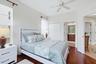 Guest bedroom with private access to full bath with large closet, hardwood flooring