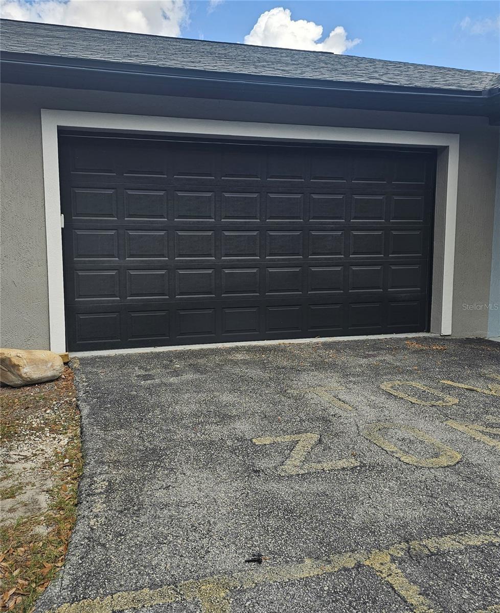 Double garage with overhead door for use with the unit