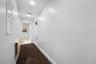 Hallway to primary bath and laundry