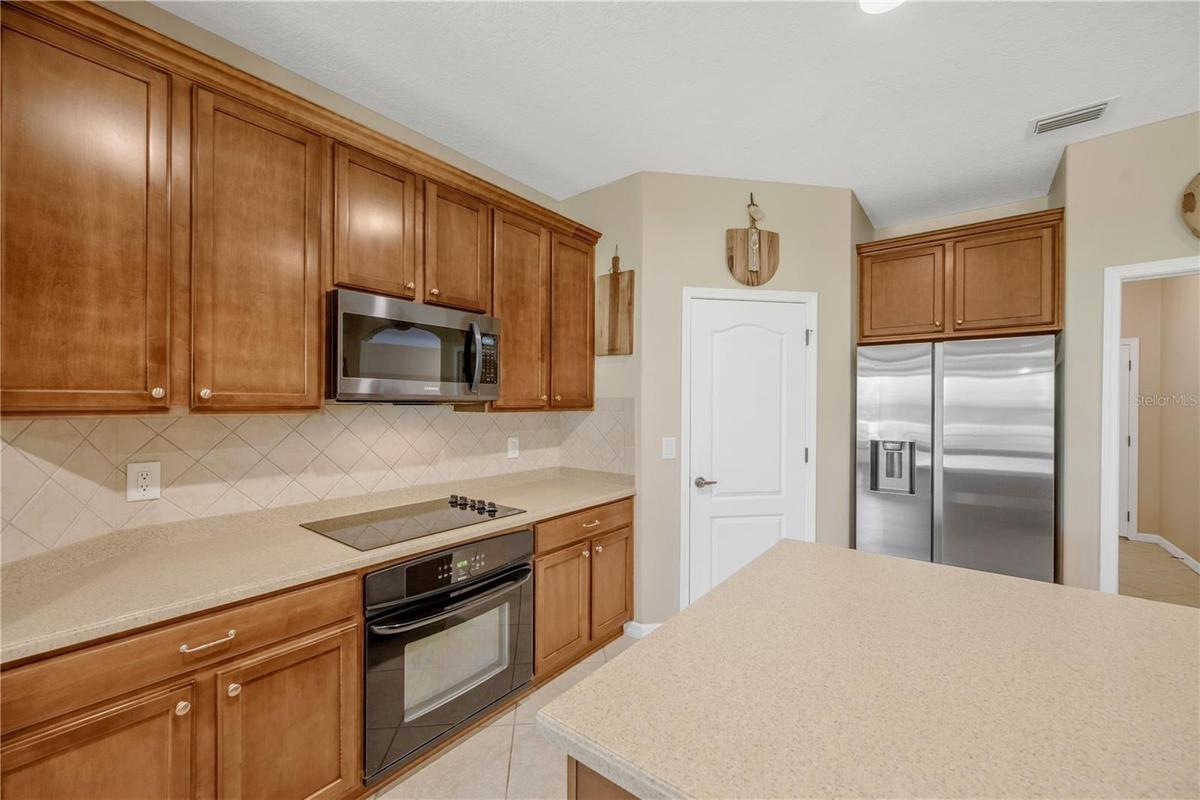 Kitchen features include a separate cooktop, built-in oven, and built-in microwave for a sleek and functional kitchen design.