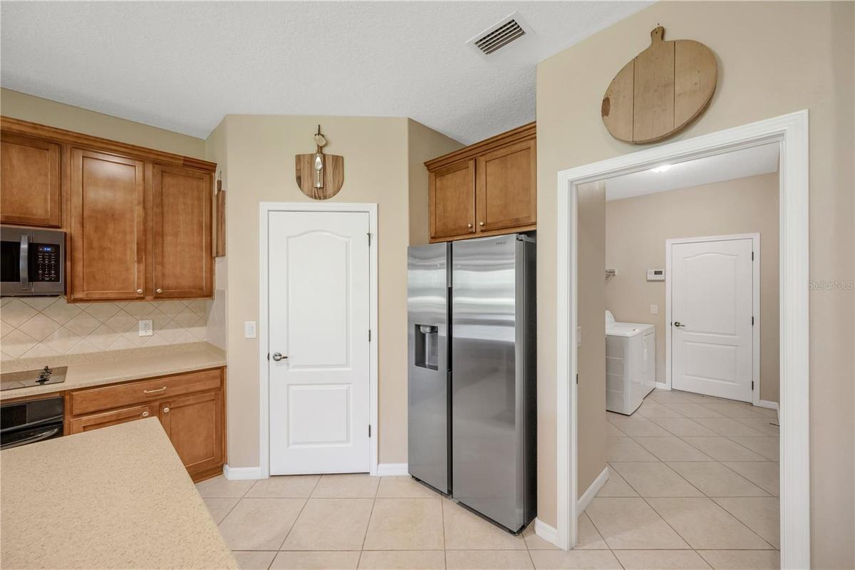 There is a corner walk-in pantry to keep all your kitchen essentials organized.  Seller plans to take kitchen refrigerator to the next home.