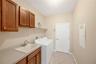 Just off the kitchen is a convenient laundry room featuring a separate utility sink and direct access to the 3-car garage. Washer and electric dryer d
