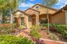 Impeccably maintained and rich in curb appeal, this residence welcomes you with a professionally landscaped yard, classic Spanish tile roof and stone 