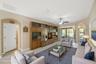The expansive 18' x 38' living and dining area flows seamlessly through sliding doors to the covered and screened lanai, creating the perfect indoor-o