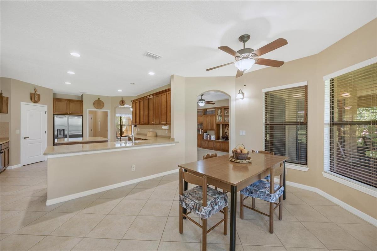 The eat-in area and kitchen workspace are connected by a single-level counter with the kitchen sink, creating an easy flow for entertaining and provid