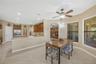 The eat-in area and kitchen workspace are connected by a single-level counter with the kitchen sink, creating an easy flow for entertaining and provid