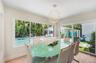 Enjoy dining with family and friends in this light and bright dining area with tropical pool views