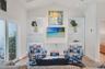 Living room showcasing the built in bookcases with the right bookcase being the hidden doorway to the primary suite