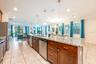 The expansive open-concept main floor seamlessly blends the Living Room, Dining area, and CHEF'S KITCHEN into one grand gathering space — ideal for ho