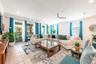 The Living Room features a striking picture-frame accent wall and sliding glass doors that open to your PRIVATE OUTDOOR OASIS.