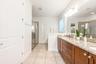A spa-inspired en suite bath is complete with a GENEROUS WALK-IN CLOSET, dual sinks, garden tub, step-in shower, and private water closet.