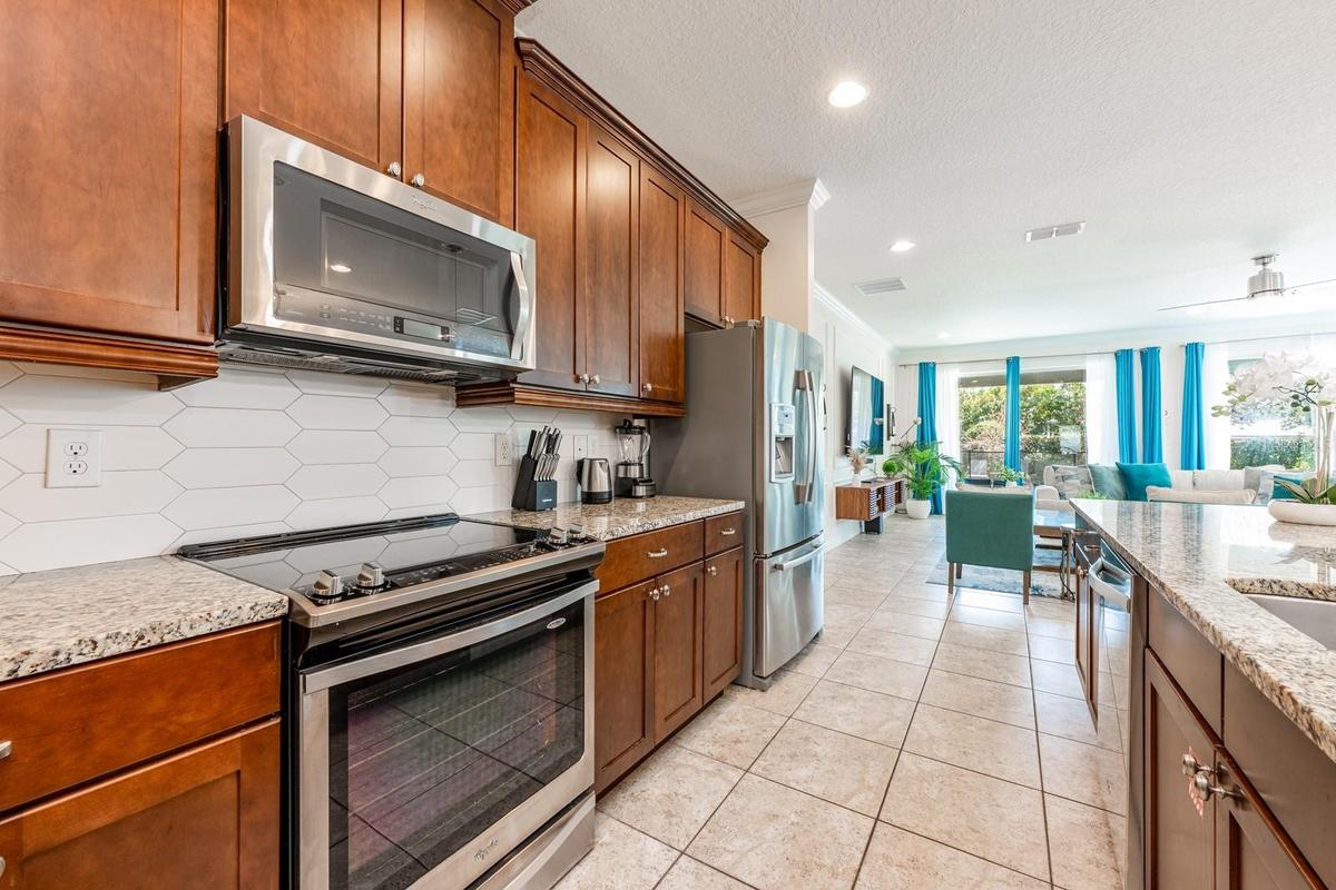 At the heart of the home, the UPDATED Kitchen is both stylish and functional, featuring 42-inch cabinetry, GRANITE COUNTERTOPS, stainless steel applia