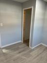 Empty room with light wood-type flooring and baseboards