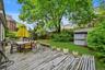 Deck featuring outdoor dining space, a storage shed, and a fenced backyard