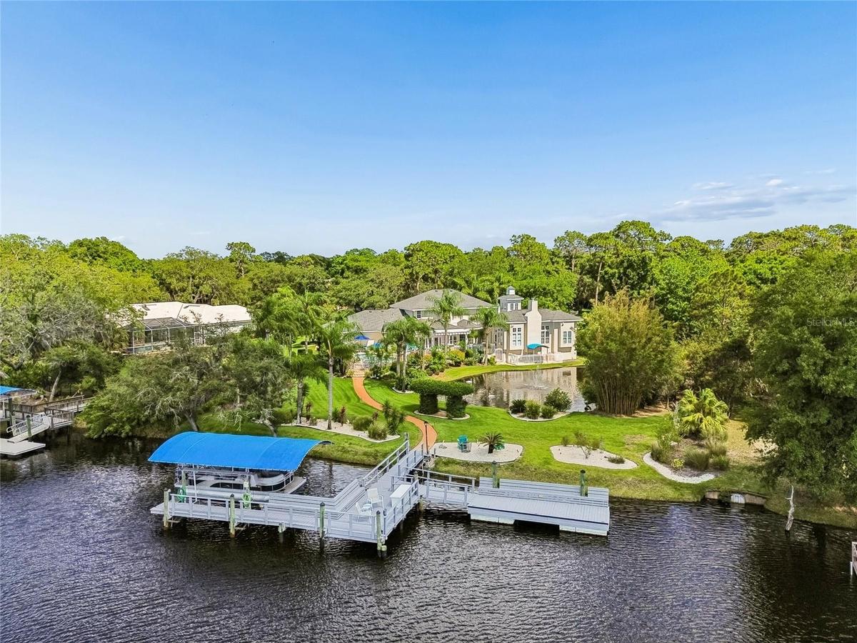 Gulf Access with a private pond. Over 150ft on NEW seawall. 10,000 lb boat lift. Still dock and floating dock.