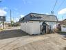 Freestanding Corner Building with Prominent Signage and Ample On-Site Parking