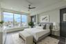 2nd Bedroom: This light-filled bedroom offers sweeping views through a wall of floor-to-ceiling windows that capture both the cityscape and the Intrac