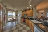 Kitchen with small eating area and the access to terrace/deck