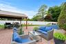 Fenced backyard featuring a gazebo, an outdoor hangout area, a patio area, outdoor dining area, and grilling area