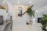 Staircase with marble finish floors and recessed lighting