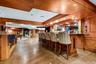 Large custom bar and stunning concrete floors throughout the lower level