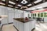 Renovated eat in kitchen with dramatic coffered ceilings and butler's pantry with prep area