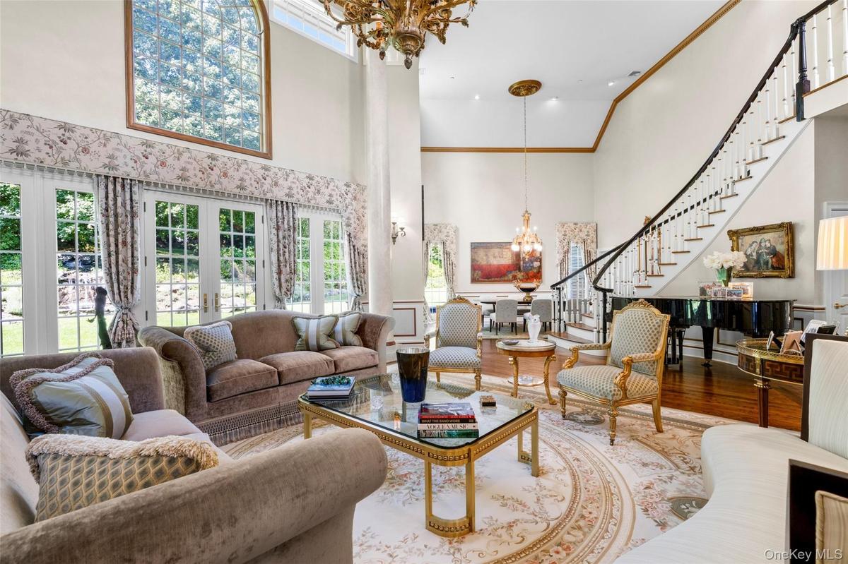 Dramatic 21 ft ceilings in the living and dining rooms. Floor to ceiling windows with french doors throughout