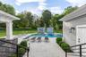 French doors from the new great room lead directly to the pool, cabanas and entertainment space