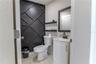 Half Bath in Florida Room with Wood Slat Wall Accents and Shelves