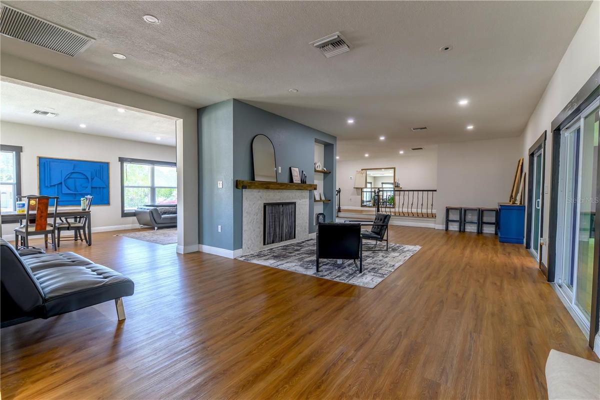 Left to Right:  Dining/Living Room, Fireplace Sitting Area/2nd Living Room Space, (2) Step up Platform to Primary Bedroom on Left & Bedroom 2, 3, & Ma