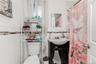 Bathroom featuring white subway tile walls with a decorative mosaic accent band