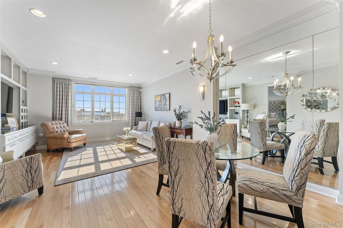 Hardwood floors and oversized windows create an inviting atmosphere.