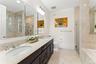 Primary bathroom with double vanity, stall shower and soaking tub.