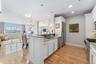 Beautiful eat-in kitchen with stainless steel appliances, open to the dining area and family room