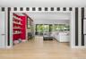 Hardwood-finish flooring extending into an open-concept living space with a fireplace and built-in shelving