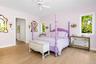 Spacious First Floor Primary room featuring light wood-finish flooring, white baseboards, and a white ceiling with a ceiling fan