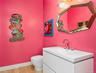 Powder Room - Modern vanity with integrated sink, chrome faucet, and geometric mirror