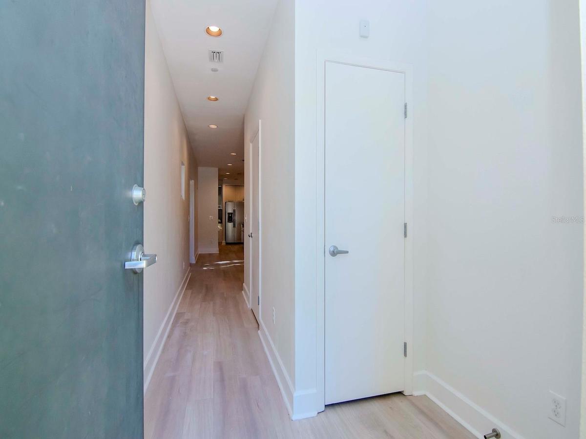 Front entry featuring a three-story foyer filled with natural light from an expansive oversized window.