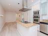 1st level - Open-concept featuring a sleek modern kitchen, dining area, and light-filled living space designed for effortless everyday living and ente